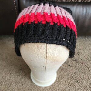 A custom handmade black, purple and red pom pom knitted hat